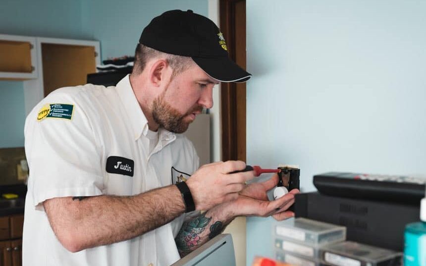 Technician helping a homeowner with a thermostat